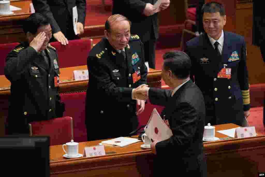 2018年3月17日,中国国家主席习近平在第十三届全国人民代表大会第一次会议结束时在北京人民大会堂与中央军委纪委书记兼中纪委副书记张升民上将握手。右侧为新的国家军委委员、海军上将苗华,敬礼者是上届国家军委委员赵克石。