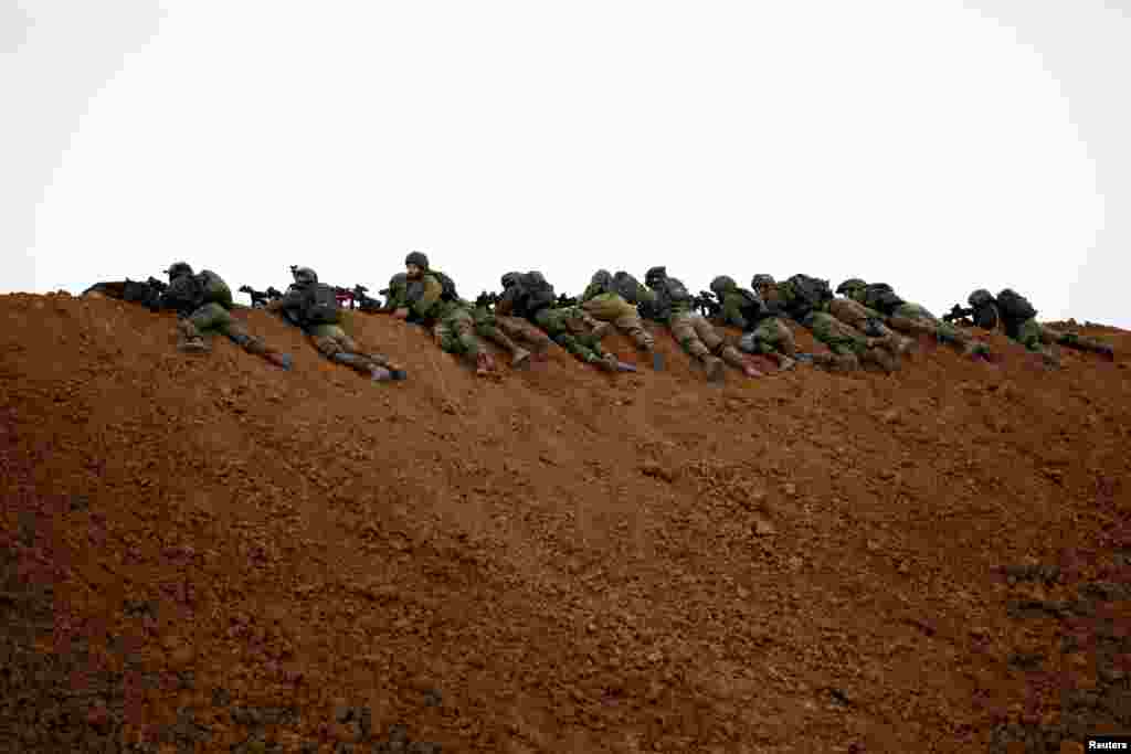 Israeli soldiers are seen next to the border fence on the Israeli side of the border with the northern Gaza Strip, Israel.