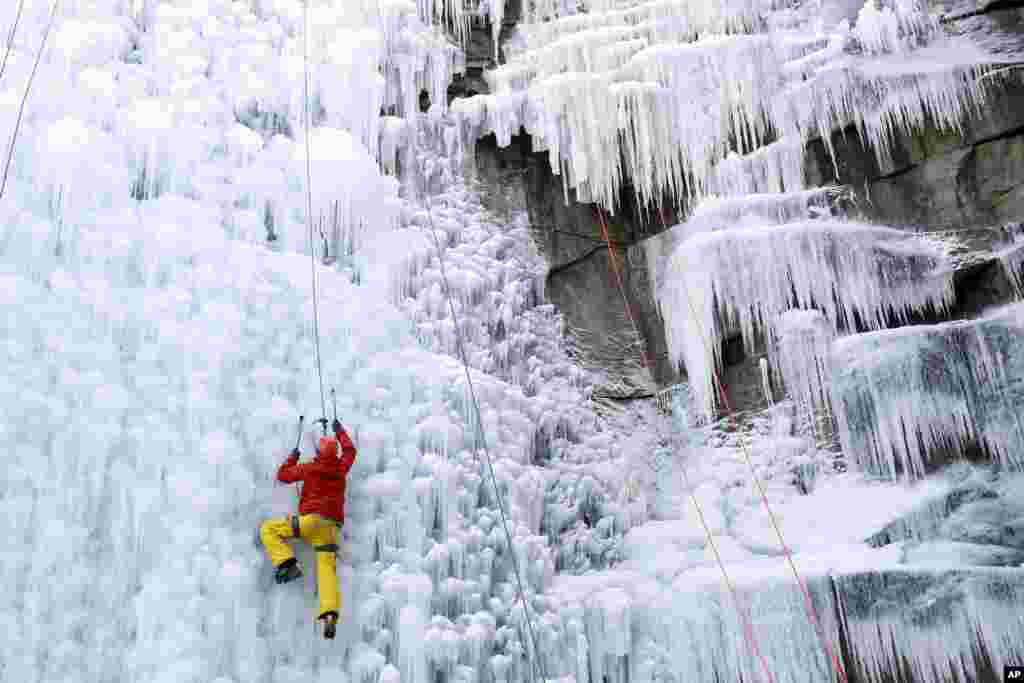 A man climbs up an artificial ice wall in Liberec, Czech Republic.