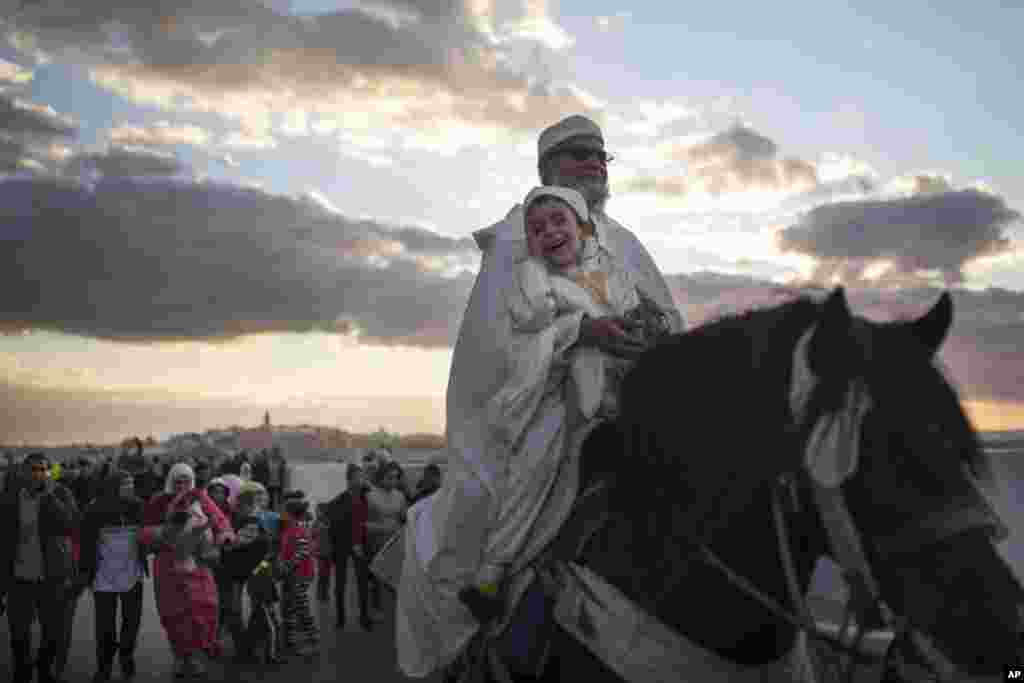 People take part in an annual parade celebrating the birth anniversary of Prophet Muhammad, in Sale, near Rabat, Morocco.