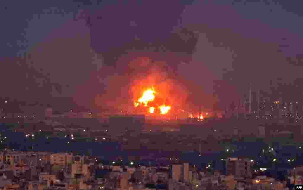 Smoke billows from the site of a refinery fire in the Iranian capital Tehran. A fierce blaze broke out at a refinery in southern Tehran after a liquefied gas line leaked and exploded, the head of the capital's crisis team said on state television. 