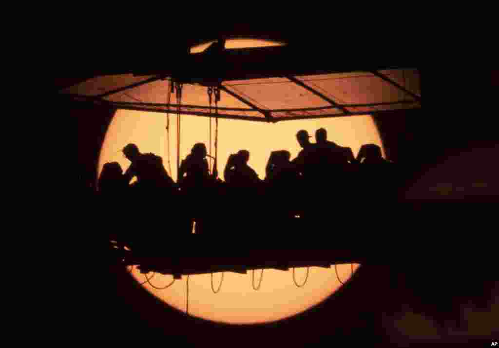 People have dinner on a platform raised by a crane to a height of 50 meters as they participate the traveling international project 'Dinner in the Sky' in St. Petersburg, Russia, June 2, 2021.