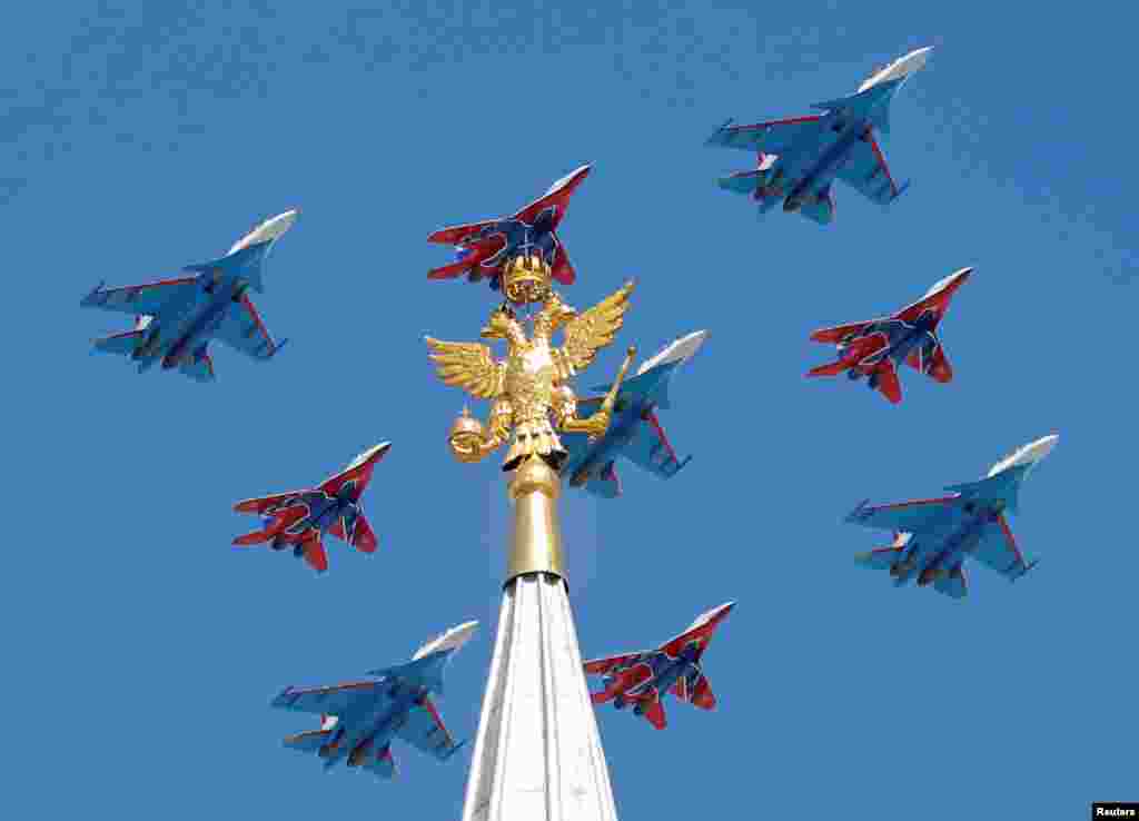 Russian army MiG-29 jet fighters of the Strizhi (Swifts) and Su-30 jet fighters of the Russkiye Vityazi (Russian Knights) aerobatic teams fly in formation during the Victory Day parade, marking the 73rd anniversary of the victory over Nazi Germany in World War II, in central Moscow, Russia.