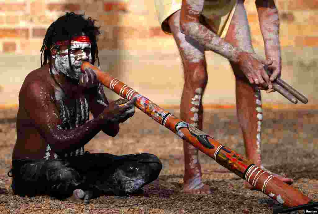 Aboriginal performer known as 'Turtle' plays a didgeridoo as he participates in a ceremony with fellow performer Terry Olsen to mark the start of National Reconciliation Week for Aboriginal and Torres Strait Islanders in Sydney, Australia.