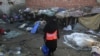 A health worker visits Lahore's slums to administer the polio vaccine to infants, Pakistan, December 19, 2012. 
