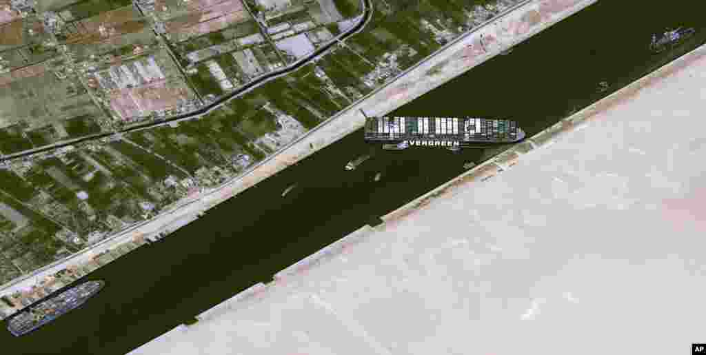 This satellite image from Cnes2021, Distribution Airbus DS, shows the cargo ship MV Ever Given stuck in the Suez Canal near Suez, Egypt.&nbsp;The skyscraper-sized cargo ship wedged across the Suez Canal further imperiled global shipping as at least 150 other vessels needing to pass through the crucial waterway idled, authorities said.