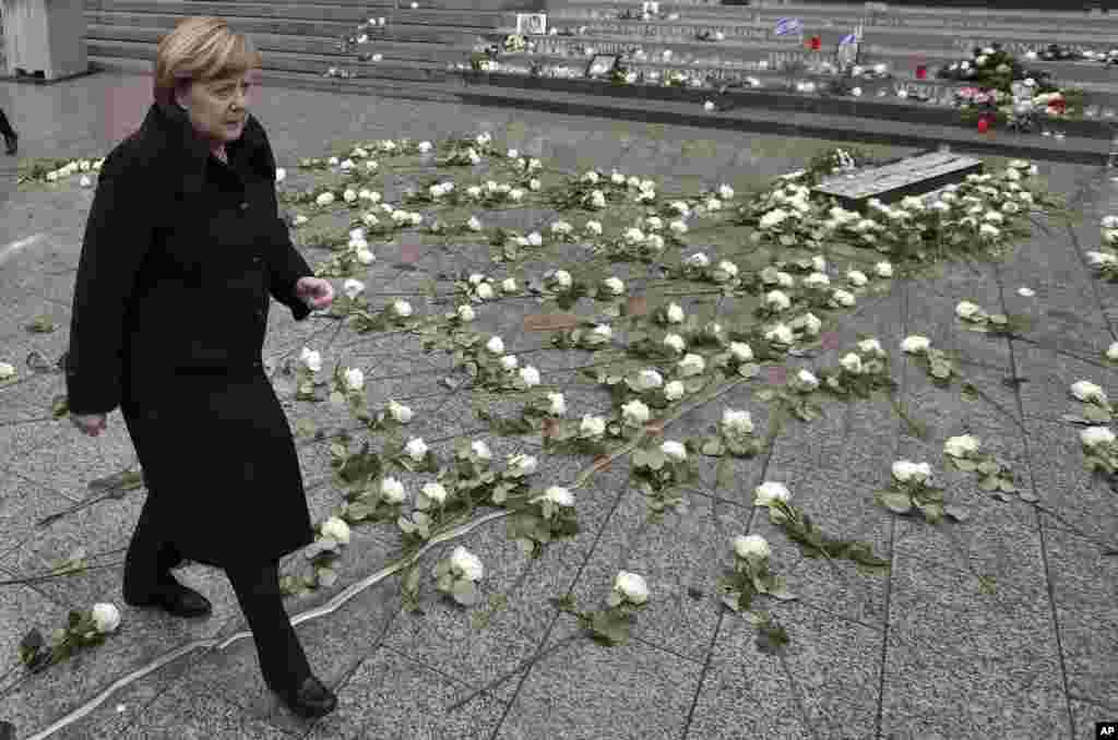 German Chancellor Angela Merkel arrives for a press statement after the opening of a memorial site in Berlin, Germany, Tuesday, Dec. 19, 2017 to honor the victims of the Christmas market terrorist attack on the Breitscheid square at the Kaiser Wilhelm Mem