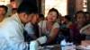 A government health worker takes a blood sample from a woman to be tested for malaria in Ta Gay Laung village hall in Hpa-An district in Kayin state, southeastern Myanmar, Nov. 28, 2014.