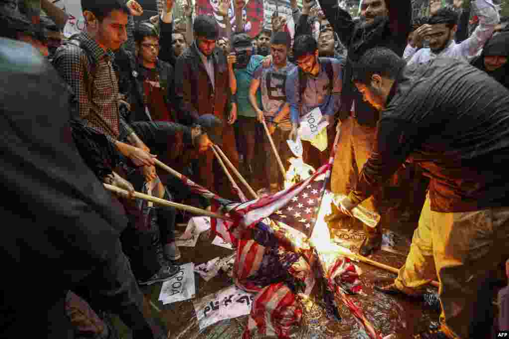 Iranians burn U.S. flags during a demonstration outside the former U.S. embassy headquarters in the capital Tehran. Iranians reacted with a mix of sadness, resignation and defiance to U.S. President Donald Trump&#39;s withdrawal from the nuclear deal, with sharp divisions among officials on how best to respond.