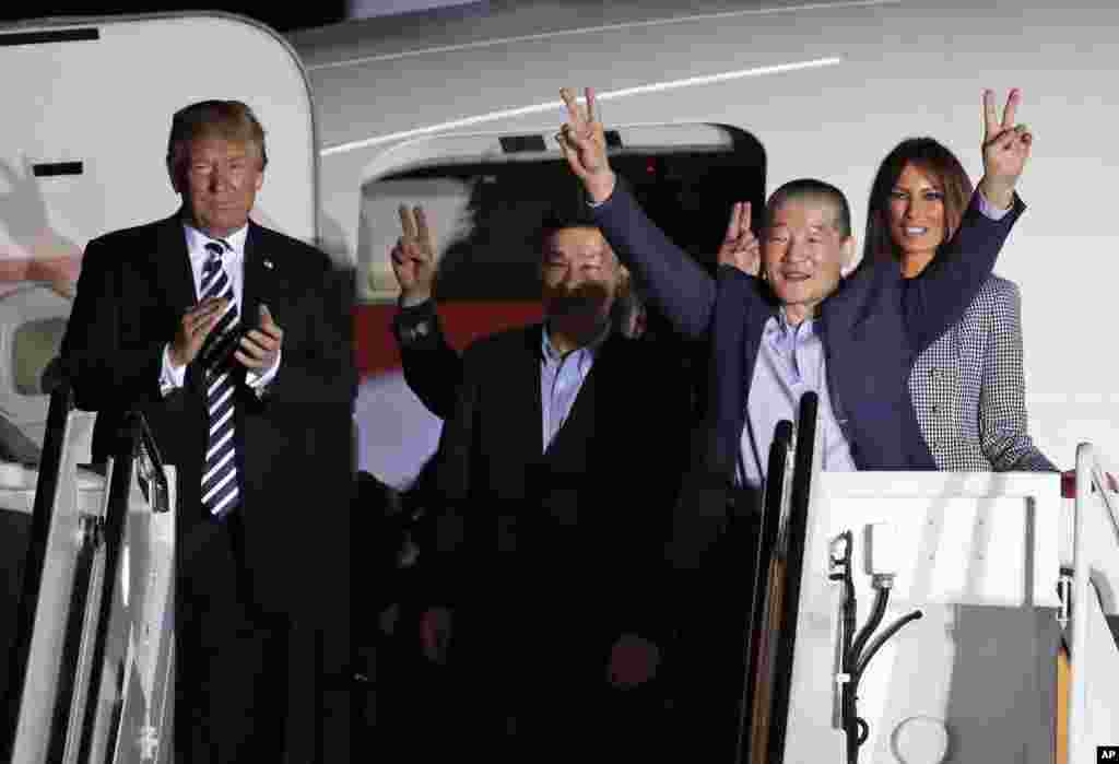 President Donald Trump and first lady Melania Trump greet former North Korean detainees Kim Dong Chul, second right, Tony Kim, center, and Kim Hak Song, behind Tony Kim, upon their arrival at Joint Base Andrews, Maryland.