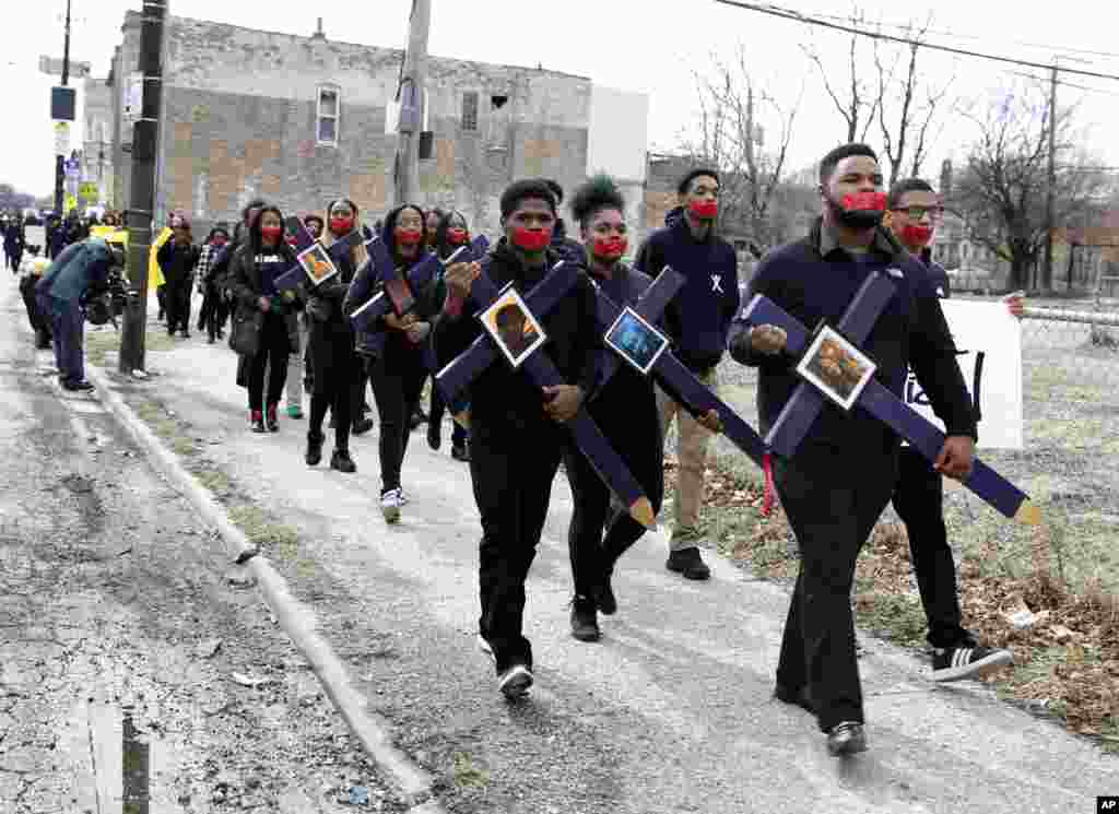 High school senior D'Angelo McDade, front right, leads a march in Chicago's North Lawndale neighborhood, Illinois, during a walkout to protest gun violence, March 14, 2018.