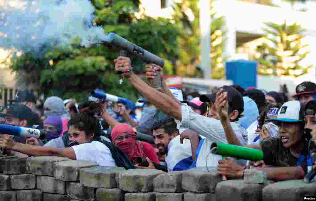 Demonstrators fire a homemade mortar during a protest against the government of Nicaragua's President Daniel Ortega, in Managua, May 30, 2018.