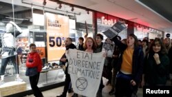 French activists protest the annual Black Friday shopping frenzy in Paris, Nov. 29, 2019. 