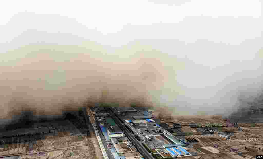 A sandstorm engulfs a village in Linze county, in the city of Zhangye in China's northwestern Gansu province.