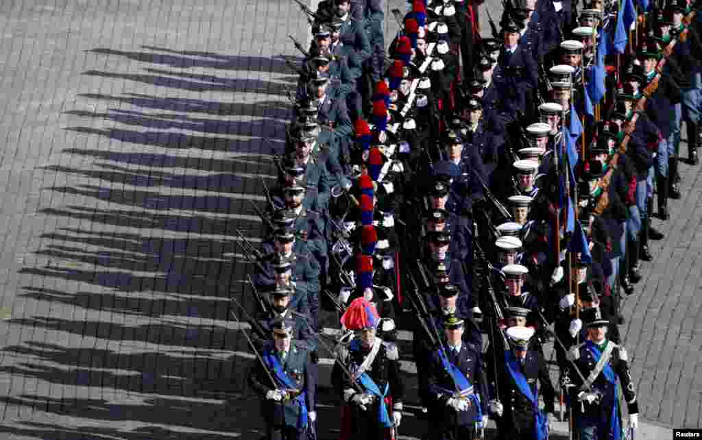 Italian army members march in front of the St. Peter's Basilica before the Easter Mass at St. Peter's Square at the Vatican.