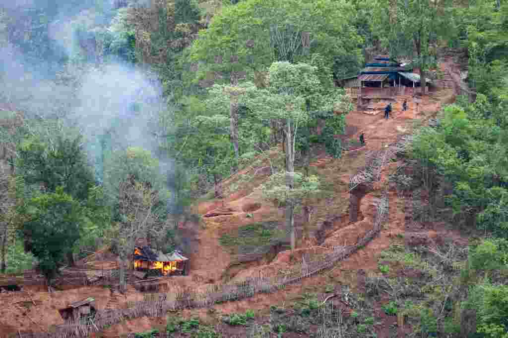 Ethnic minority Karen troops are seen after setting fire to a building inside a Myanmar army outpost near the Thai border, which is seen from the Thai side on the Thanlwin, also known as Salween riverbank in Mae Hong Son province, Thailand.