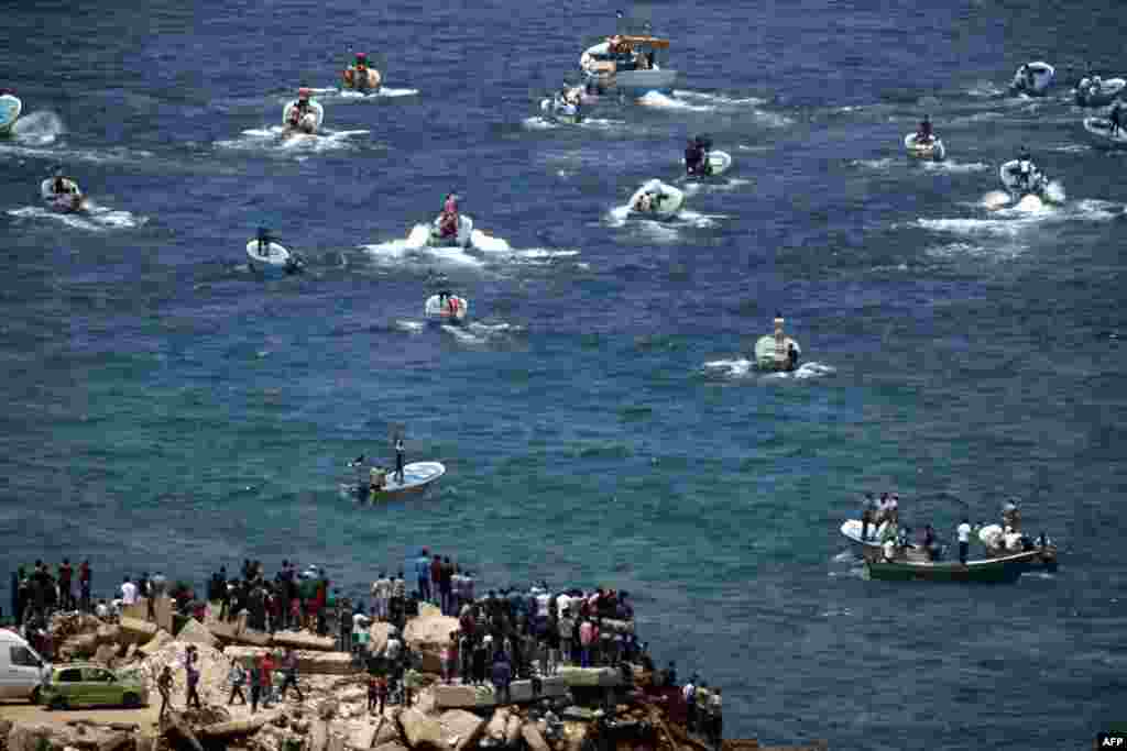 Fishing boats carrying a group of Palestinian activists who are protesting and perhaps trying to breach Israel's naval blockade on Gaza, setting to sail from Gaza City harbor. The Gaza Strip has been under Israeli blockade for more than a decade, with Israel saying it is necessary to prevent the Palestinian enclave's militant Hamas rulers from obtaining means to attack the Jewish state.