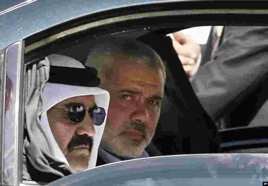 Quốc vương Qatar Hamad bin Khalifa al-Thani (trái) cùng thủ tướng Ismail Haniyeh của chính quyền Hamas quản lý Dải Gaza (phải) trên đường đến dự buổi lễ khởi công xây dựng một khu dân cư mới ở Khan Younis, phía nam Dải Gaza, ngày 23 tháng 10, 2012.