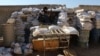FILE - A rebel fighter from the Free Syrian Army sits on a barricade as he holds a position on a front line in the northern city of Aleppo, Oct. 1, 2014. 
