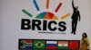 A delegate walks past a BRICS logo ahead of the 10th BRICS Summit, in Sandton, South Africa, July 24, 2018. 