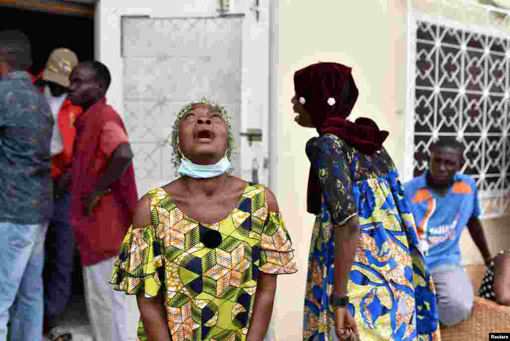 Women cry after Congo Republic's opposition presidential candidate Guy Brice Parfait Kolelas died from COVID-19 at the Union of Humanist Democrats offices in Brazzaville.
