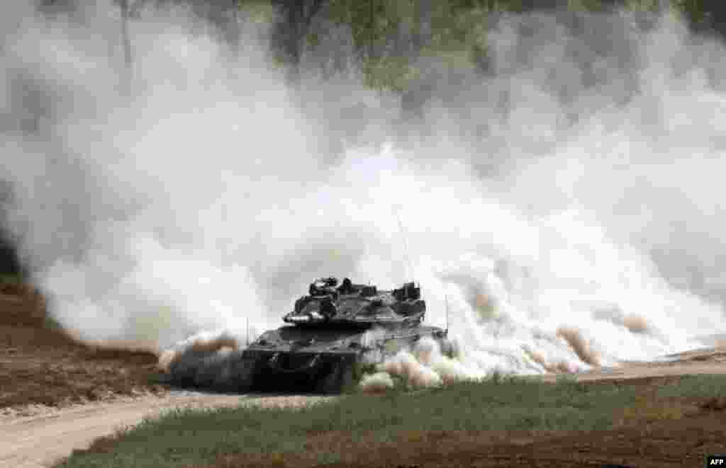 An Israeli army tank patrols along the border between Israel and the Gaza Strip. Israel's military struck more than 30 "military targets" in the Gaza Strip in response to a barrage of rocket and mortar fire from the Palestinian enclave, the army said.