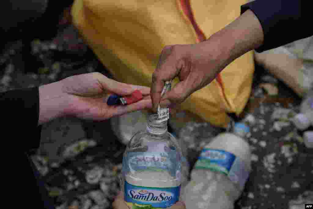Bottles containing rice, money, and USB sticks, are prepared before being thrown into the sea by North Korean defector activists on Ganghwa island, west of Seoul, South Korea. The defectors have been throwing hundreds of bottles filled with food, cash, medicine and memory sticks into the sea twice a month for more than two years.