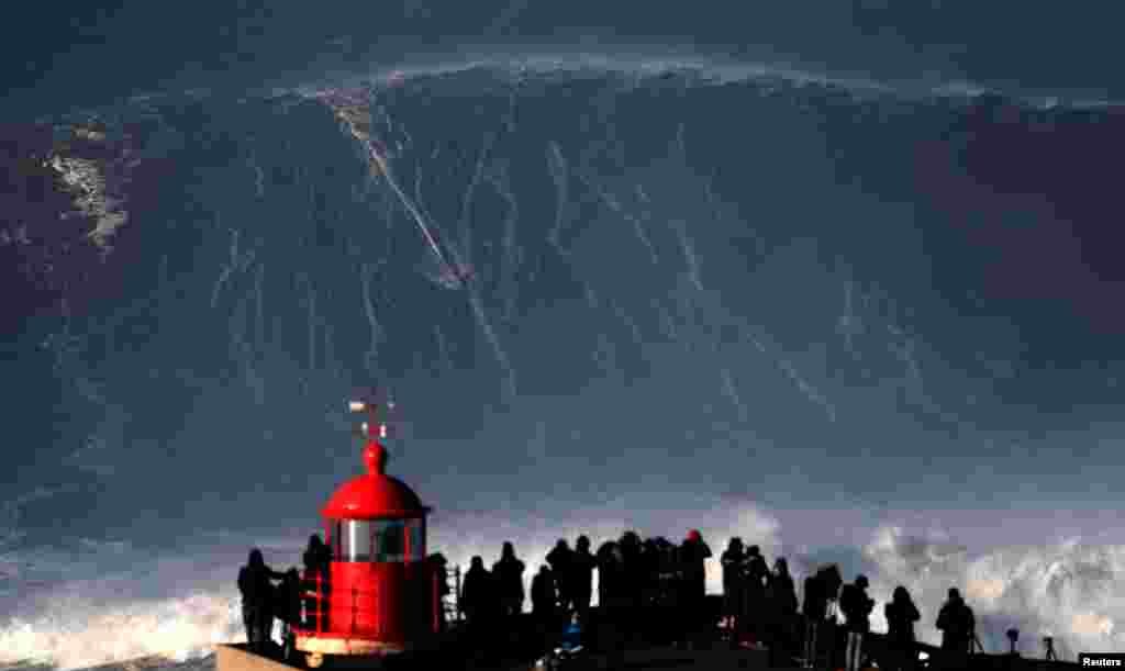 Big wave surfer Sebastian Steudtner of Germany drops in on a large wave at Praia do Norte in Nazare, Portugal.