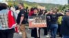 Kathy Hughes holds a sign as she takes part in a march led by New Zealand political party Te Pati Maori to demonstrate against the incoming government and its policies, in Wellington, New Zealand, Dec. 5, 2023.