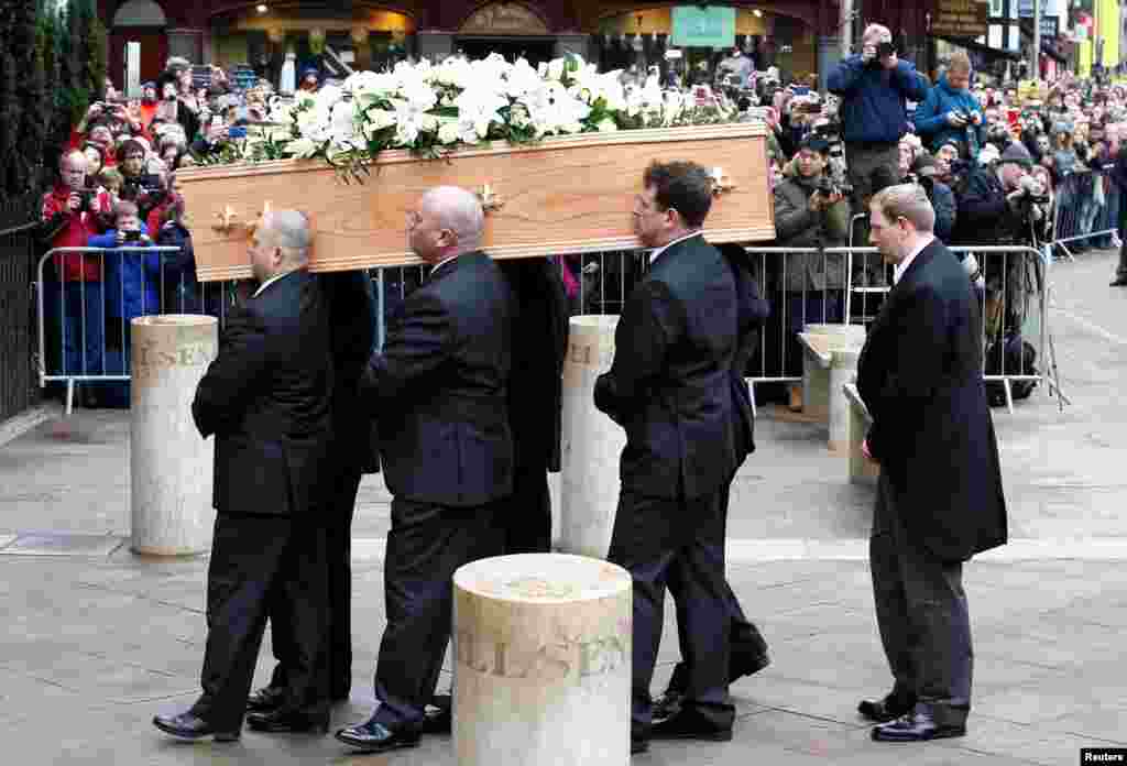 Pallbearers carry the coffin into Great St. Mary's Church, where the funeral of theoretical physicist Prof. Stephen Hawking is being held, in Cambridge, Britain, March 31, 2018.