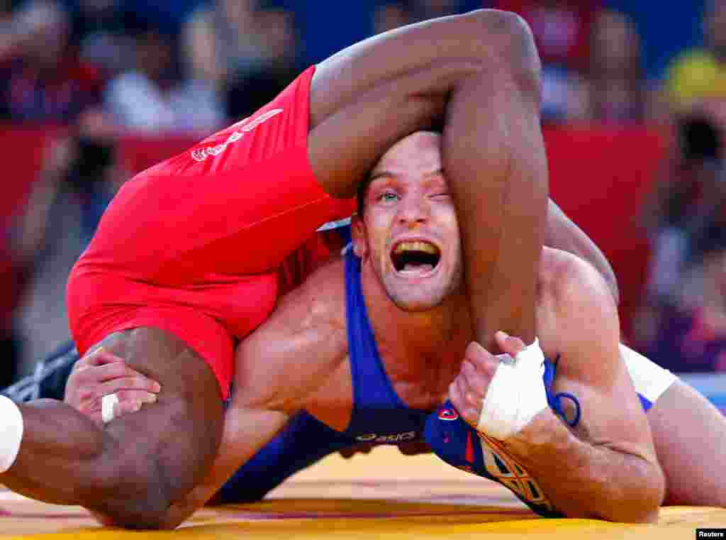 Jordan Ernest Burroughs của Mỹ (quần đỏ) thi đấu với Matthew Judah Gentry của Canada trong môn vật tự do nam, dưới 74 cân. REUTERS/Grigory Dukor
